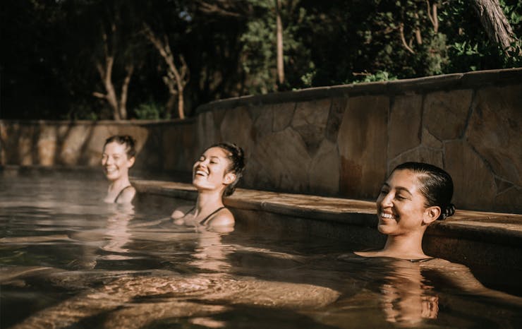 A group of people in a hot spring pool at one of the best day spas in Melbourne. 