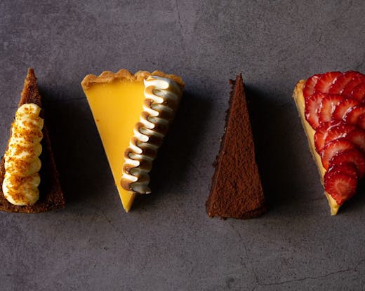 Four slices of different cakes.
