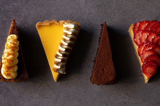 Four slices of different cakes.