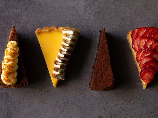 Four slices of different cakes.