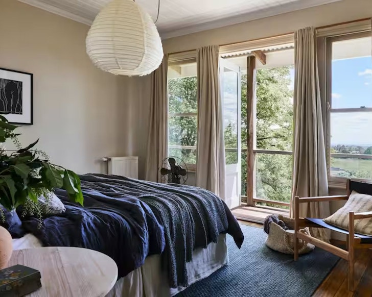 A view of the bedroom with amazing views over the countryside at Milk and Honey Airbnb one of the best romantic getaways in Australia