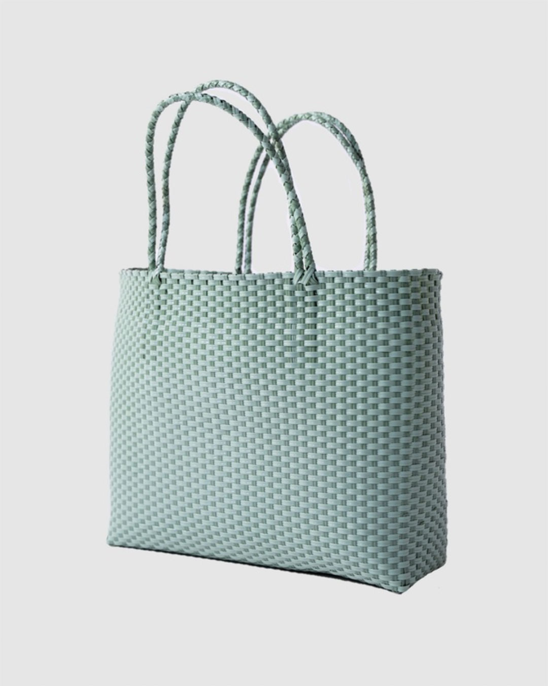 A light green tote bag woven from plastic material.