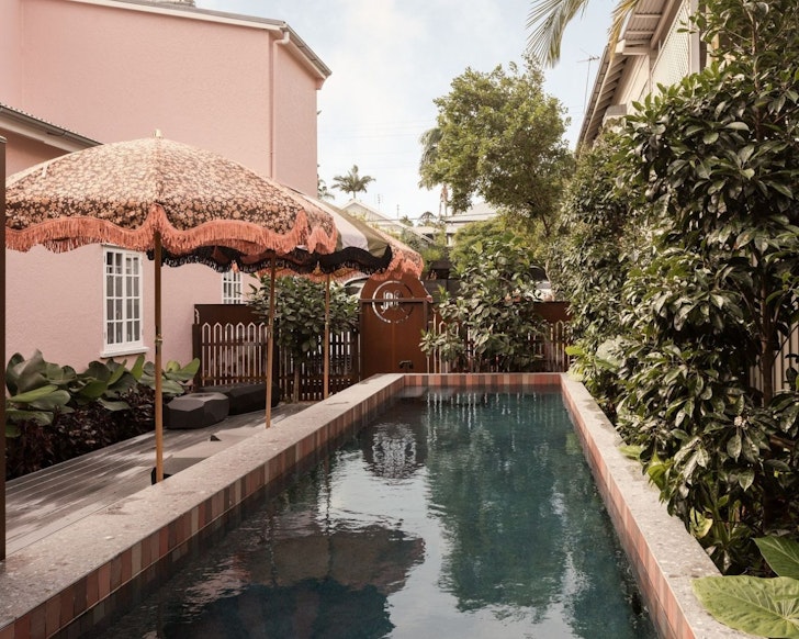 The pool with dusky pink umbrellas at Miss Midgley's one of the best hotels in Australia