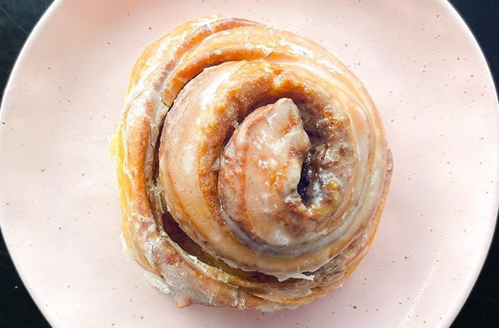 A Melbourne best cinnamon scroll on a plate.