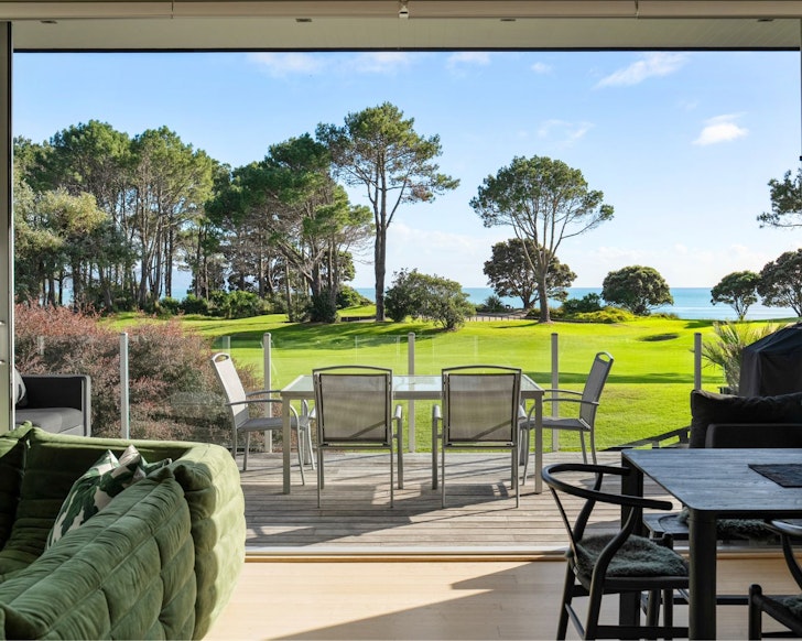 A view to the water at Modern Retreat In Matarangi best beach house Airbnbs New Zealand