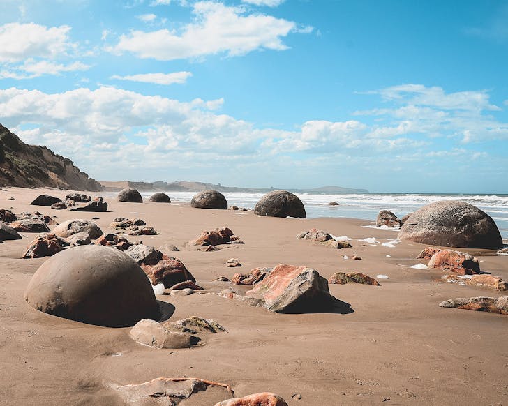 Moeraki Boulders seen strewn on the beach.