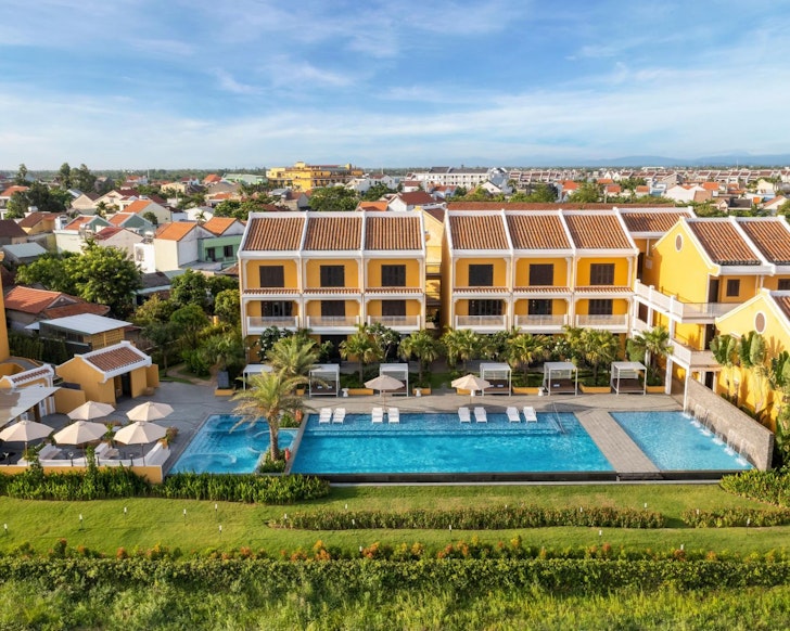 A view of the distinctive orange exterior and pool at Moire Hoi An one of the best Vietnam resorts