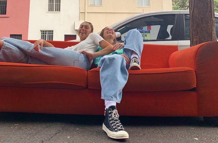 Two people hanging out on a couch