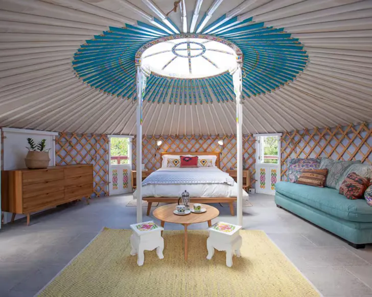 A view of the inside of the Mongolian Style Yurt with its blue roof, one of the best glamping spots in Queensland