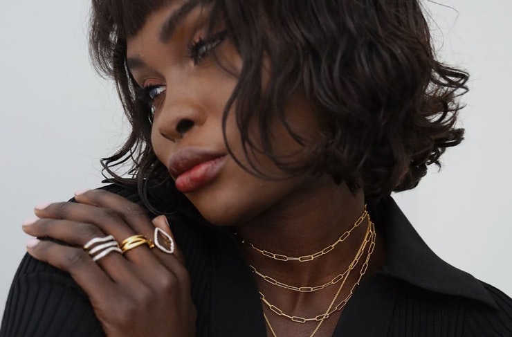 A woman wearing Monica Vinader jewellery. 