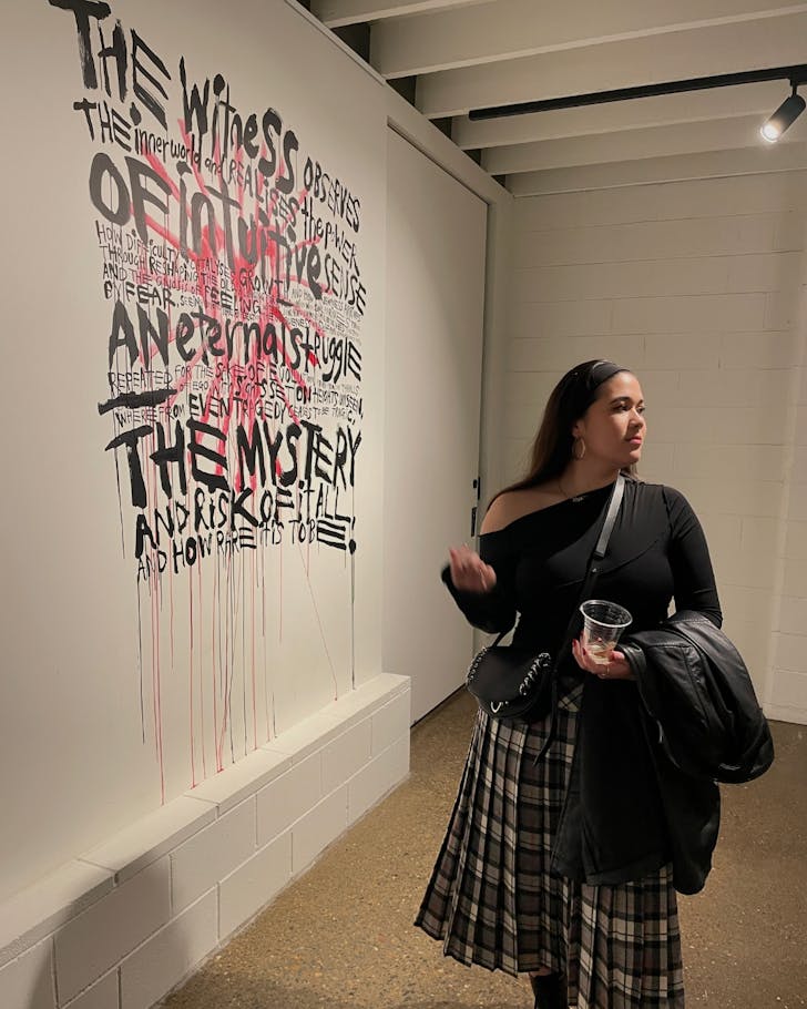 A woman looking at an art piece