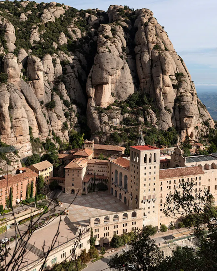 An overhead view of the town nestled in the Montserrat mountain range in Barcelona.