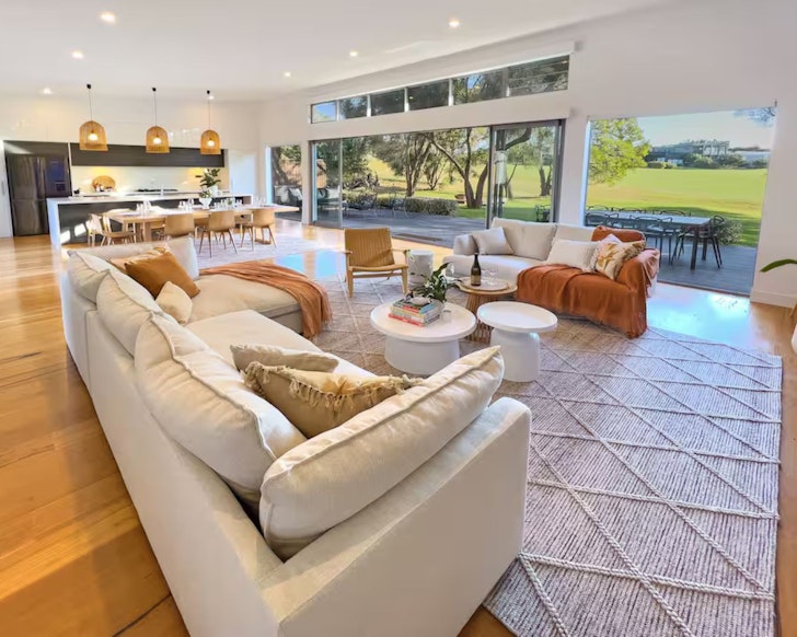 The living space at Moonah Links Peninsula Retreat luxury Airbnb accommodation looking out at the golf course