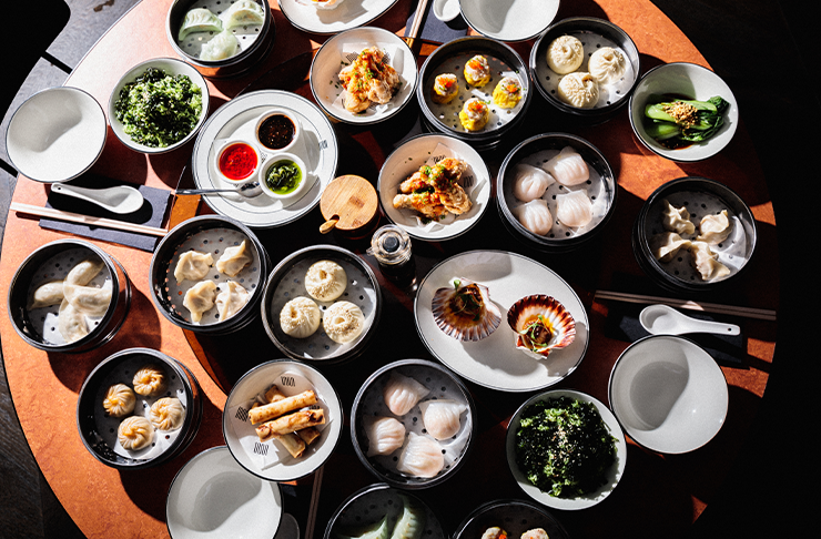 Several dishes on a dining table including dumplings and bao for Mother's Day in Melbourne