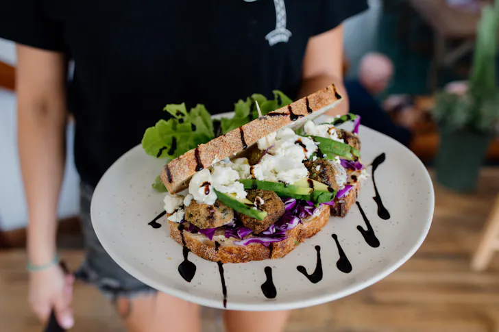 a close up of a smashed avo sandwich