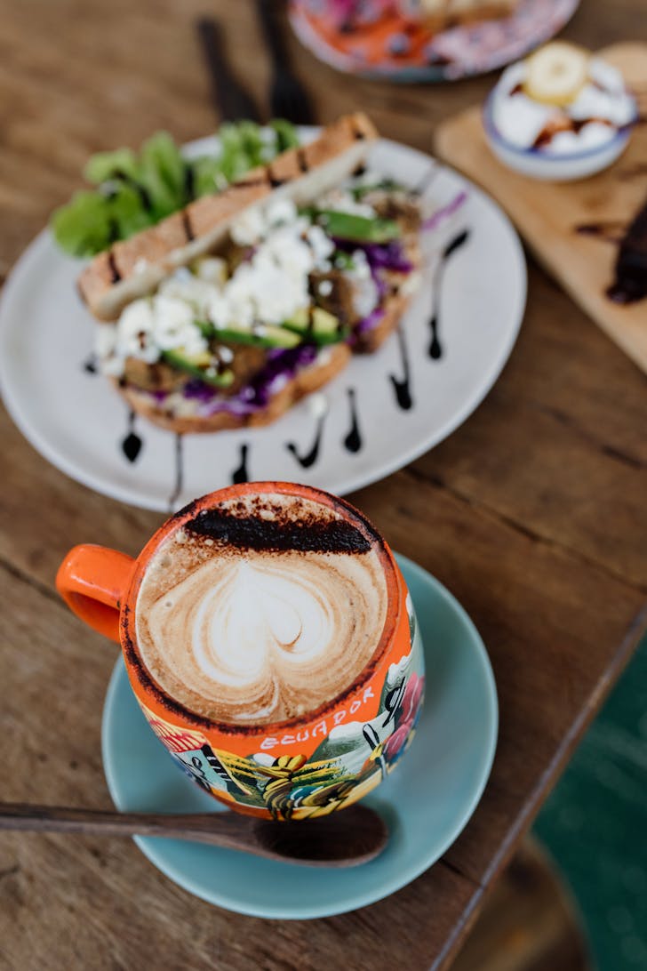 a coffee cup and a smashed avocado dish