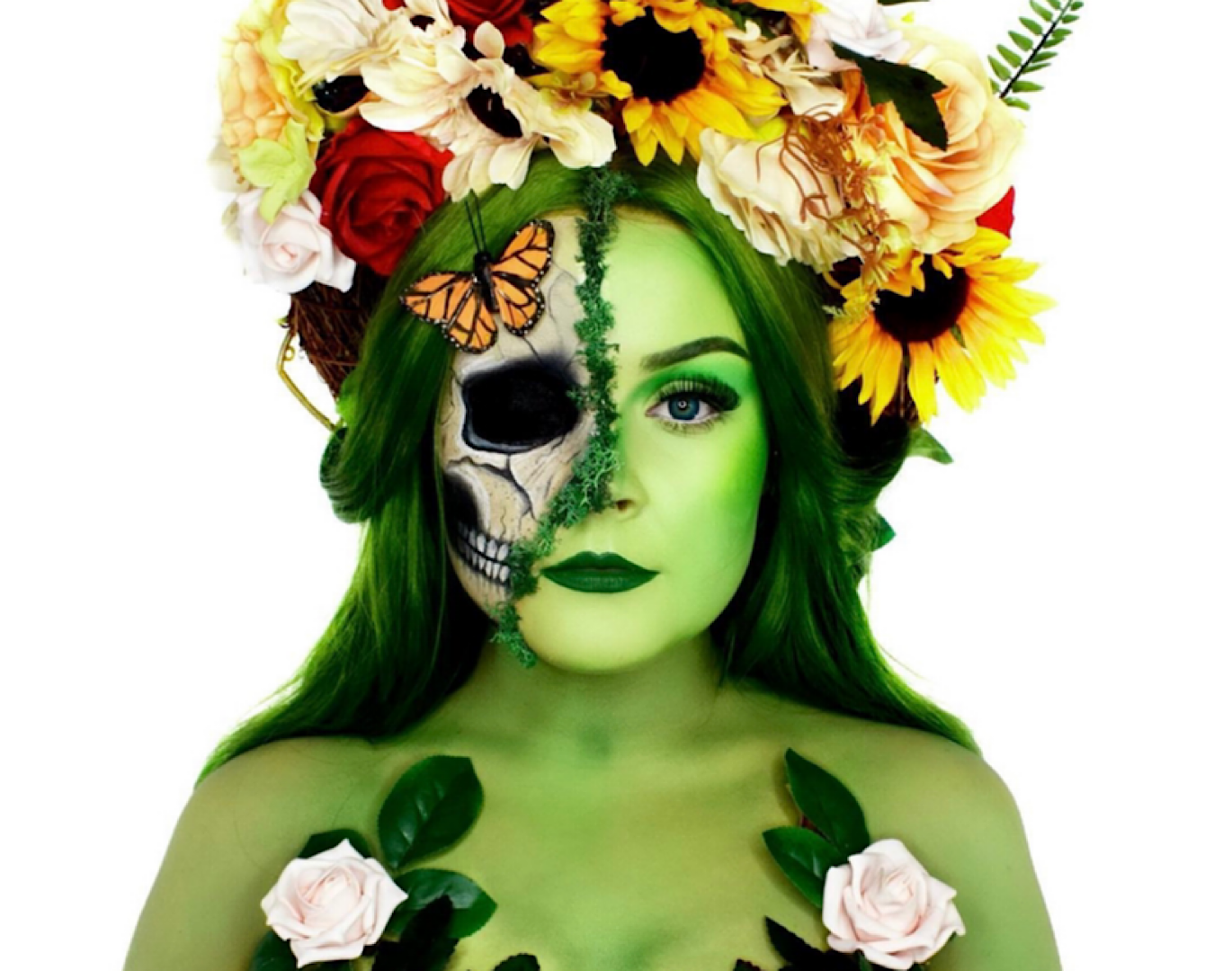 Makeup FX artist Ella Grimmant wears a floral headdress in a Mother Nature Halloween costume. Half her face is pretty green, earth mamma vibes and the other half is a skeleton. 