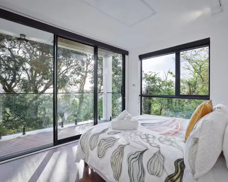 The bedroom with treetop views at Mount Pleasant Hillside Haven romantic stay near Christchurch, New Zealand