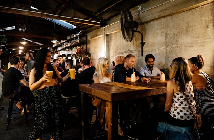 A bustling bar full of people at one of the best bars in Melbourne
