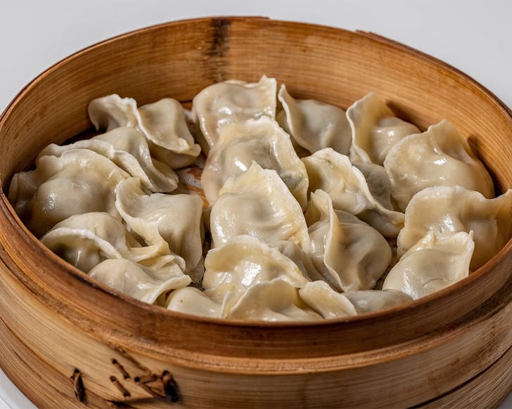 A fresh lot of dumplings in a wooden steamer await devouring at Mr Zhou's Dumplings, One of Auckland's best dumpling spots.