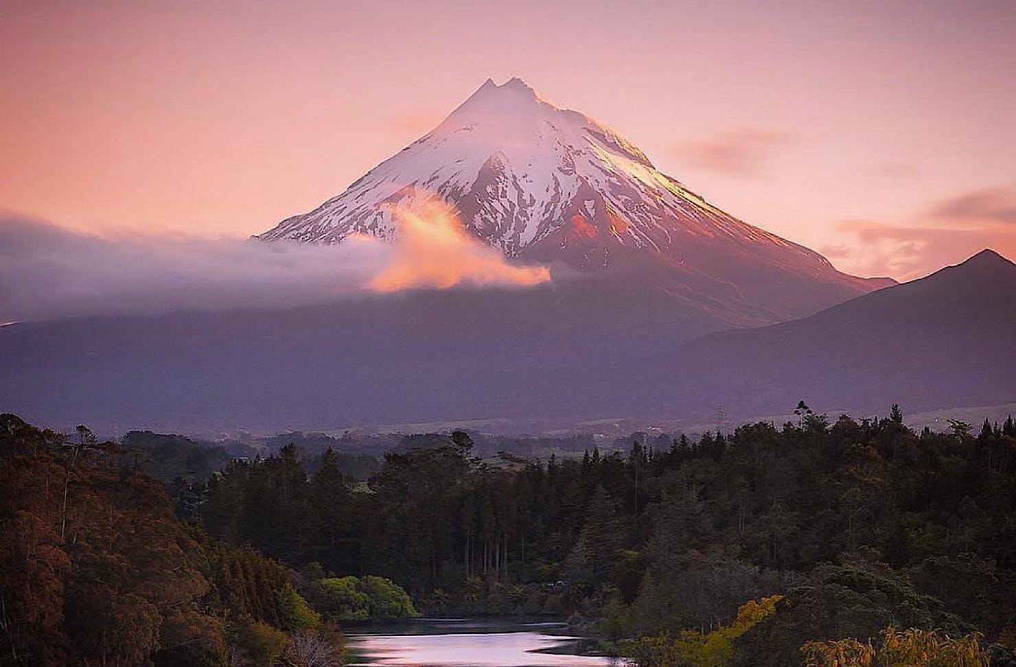 Snow-topped Mount Taranaki with minor snow cover and a beautiful purple tone. 