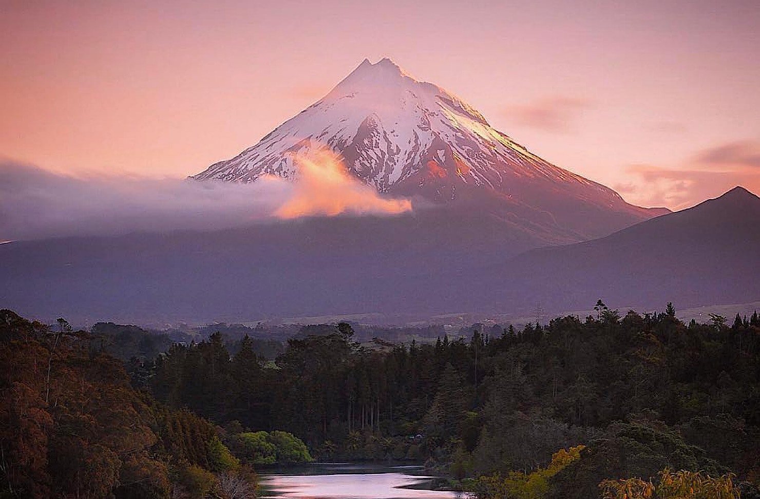 Snow-topped Mount Taranaki with minor snow cover and a beautiful purple tone. 