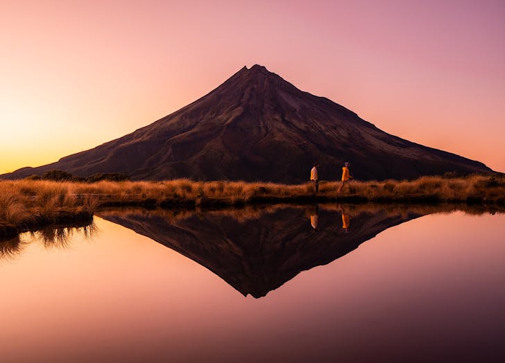 An iconic shot of Mt Taranaki taken from Pouaki Tarns where the mountain is reflected in the water. 