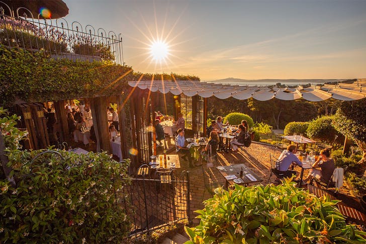 View over Mudbrick Vineyard and restaurant at dusk with people enjoying themselves everywhere.