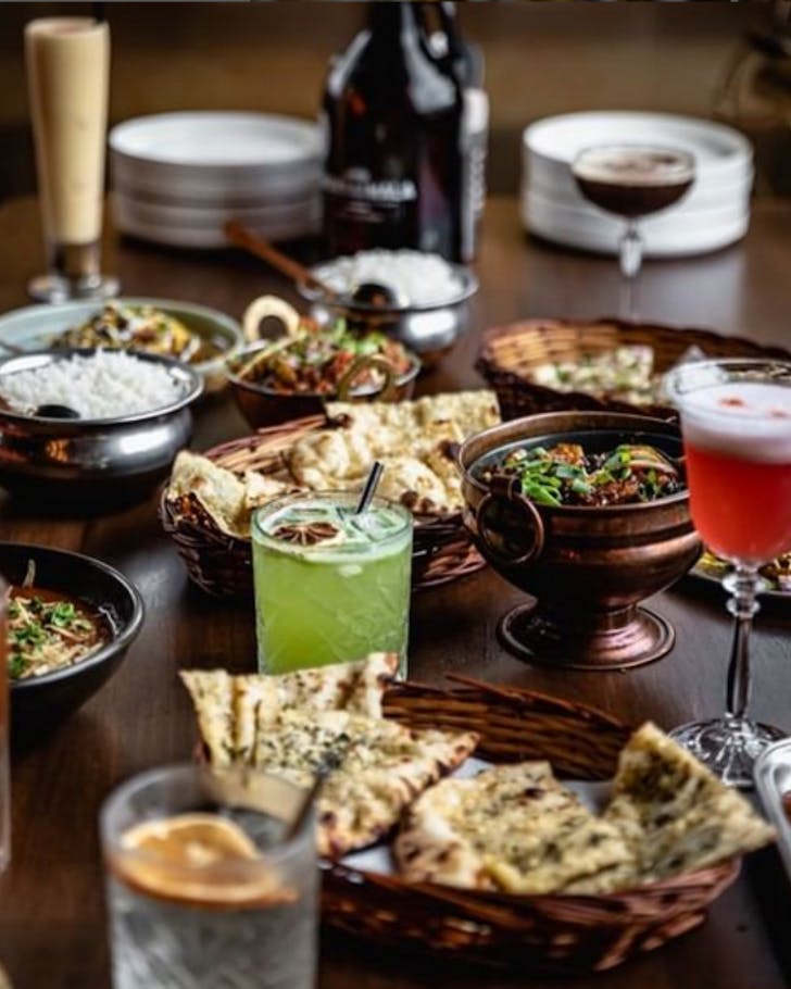 A espresso martini behind an array of dishes including bread and rice at a Ponsonby restaurants 