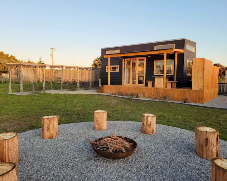 The fire pit in front of the wooden tiny home at Murray's Place in Victoria