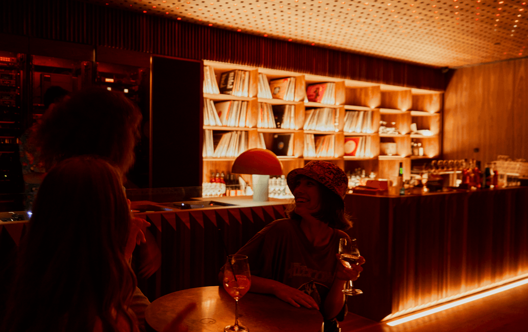Two people drinking wine inside a music room at the best bar in melbourne