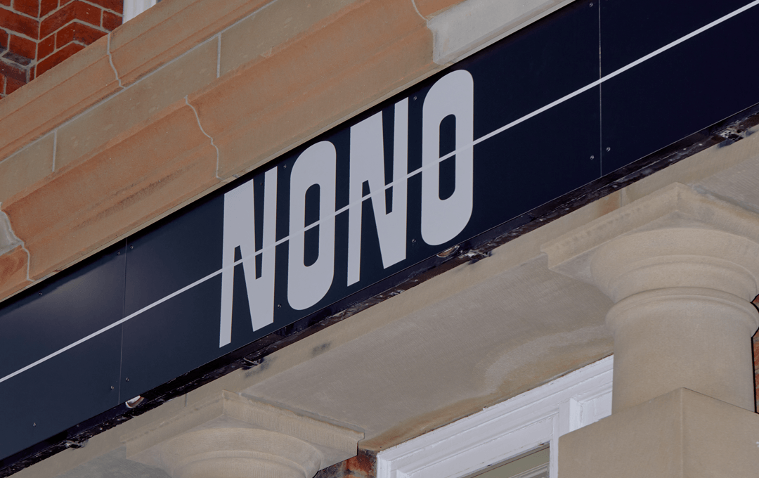 A sign on a building that reads 'NONO'.
