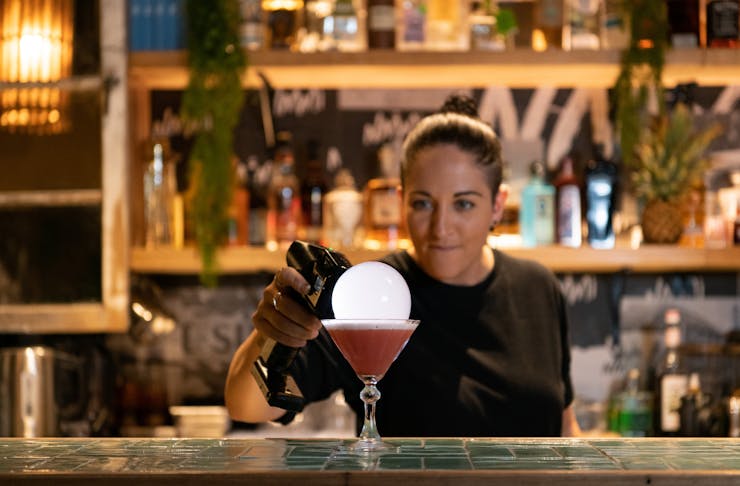 a bartender preparing a bubble cocktail