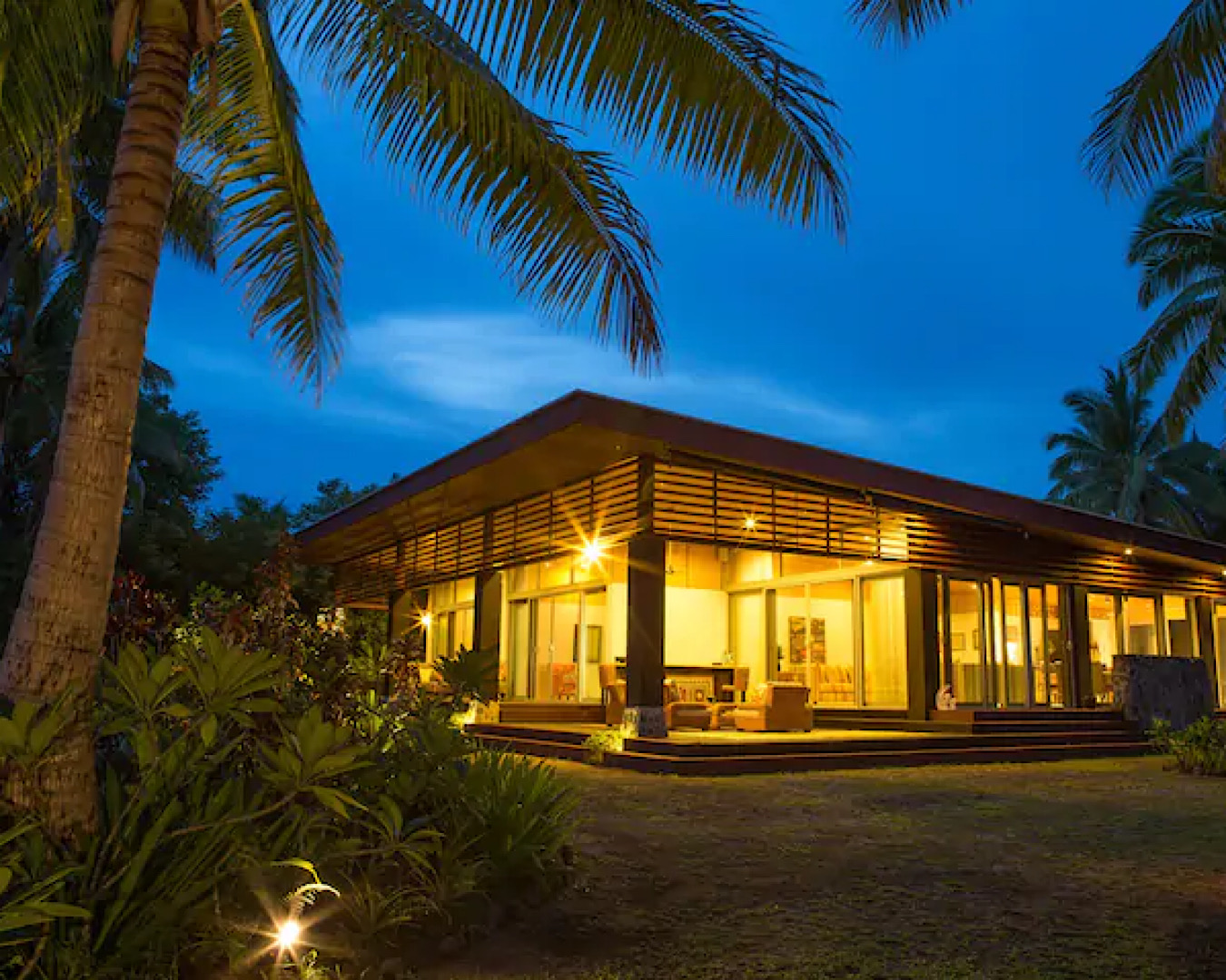 Natabe Retreat, one of the best Airbnbs in Fiji stands gloriously lit in the early evening. 