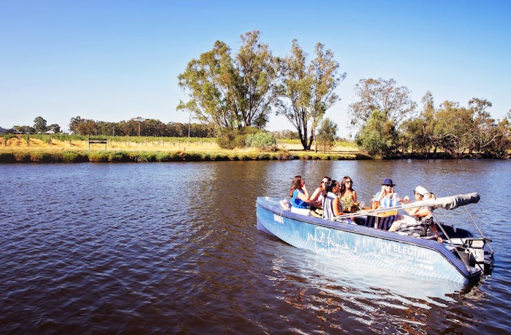 5 friends sit in one of Nauti Picnic's boat on the Swan River