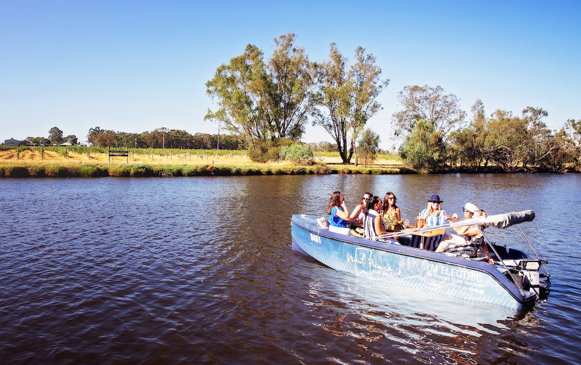 5 friends sit in one of Nauti Picnic's boat on the Swan River