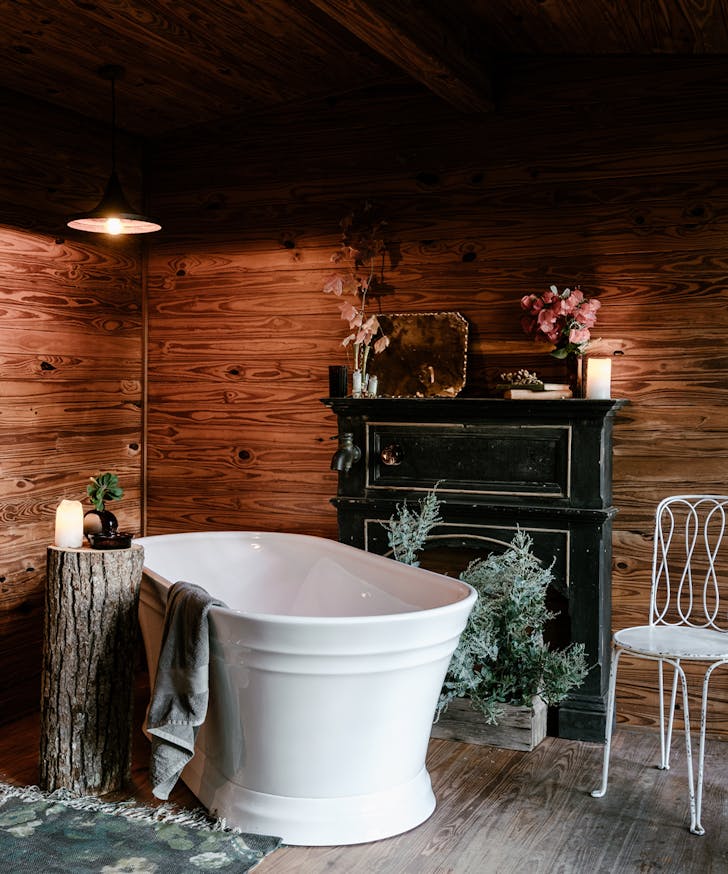 a freestanding bath in a wooden cabin