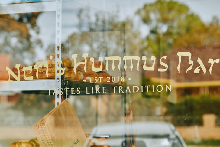 The shop front window of Neri's Hummus Bar