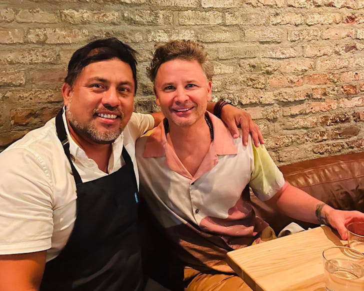 Chefs Ricardo Zarate and Nic Watt sit arm in arm in West Hollywood LA in July 2021. 