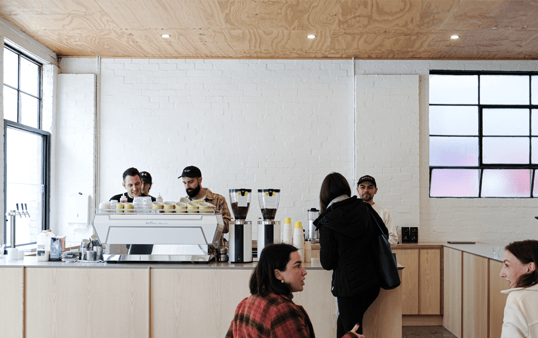 People working on a coffee machine inside one of the best cafes in Melbourne for 2023.