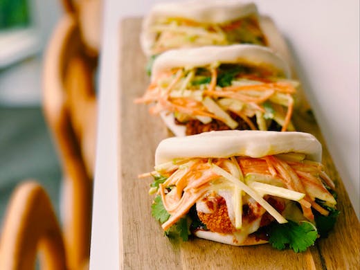 3 chicken parmi bao buns on a platter from Nik & Kolo