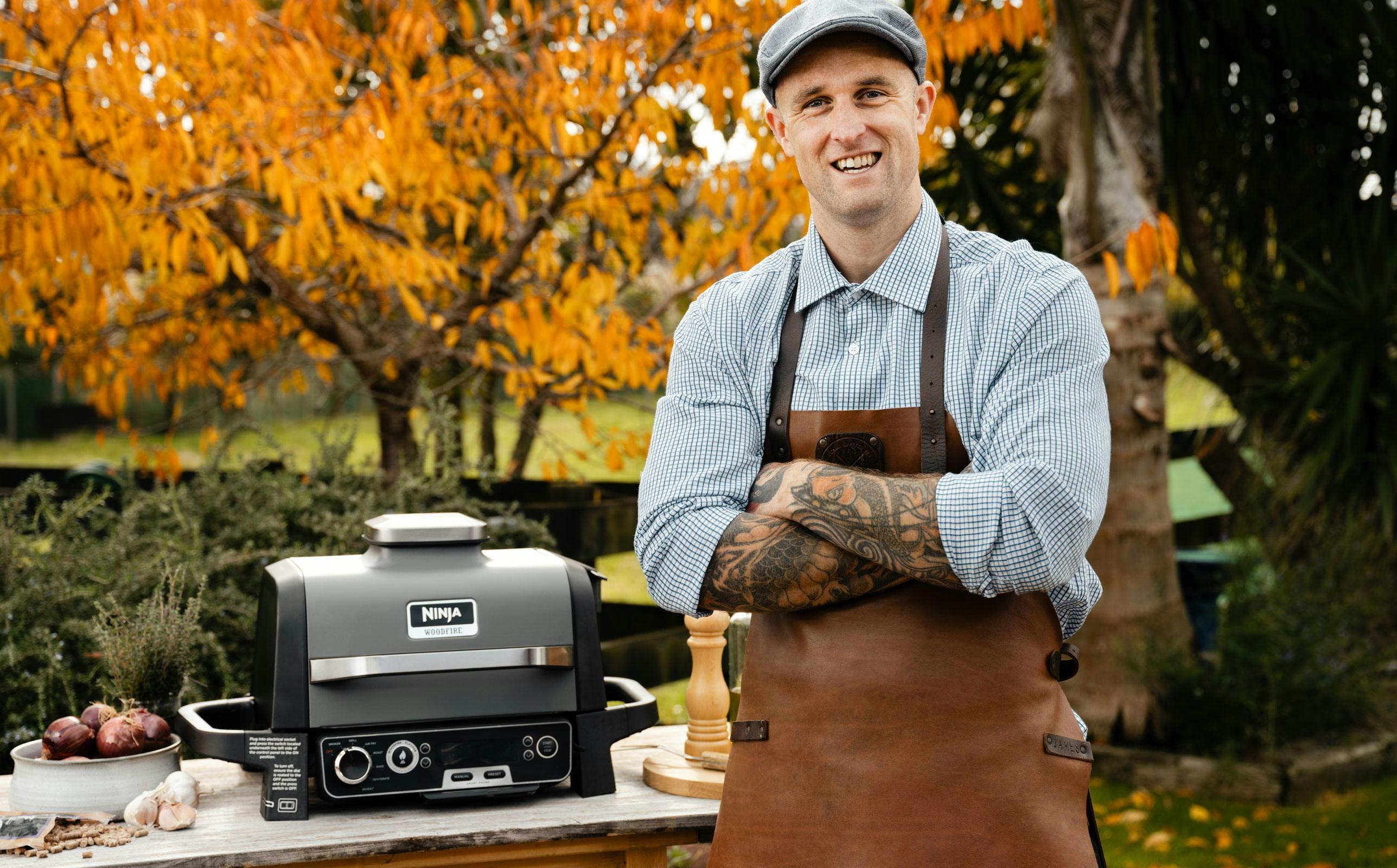 James Smith smiling to camera with the Ninja Grill in the background