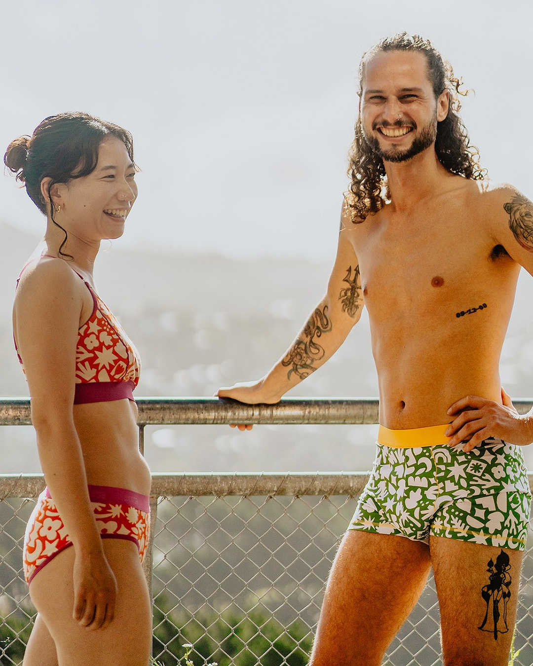 Two people look happy wearing Nisa Swimwear, one of the best swimwear labels in NZ.