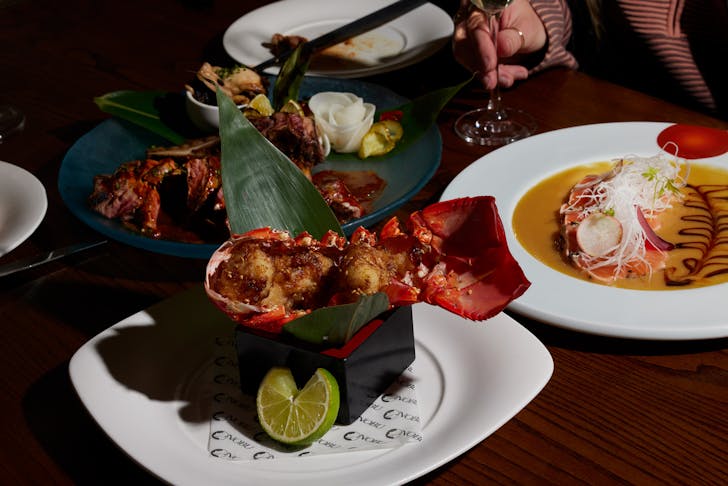 lobster tail and plates of food