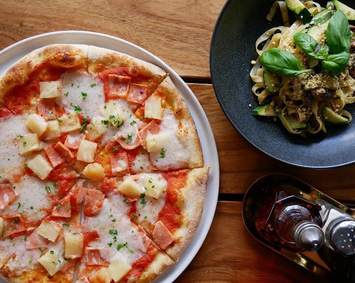 Picture of an Italian pasta dish and Hawaiian pizza from Nolita 