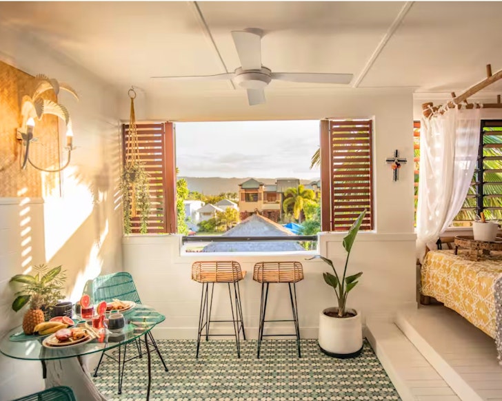 A view of the daybed and seats at the window with a view at Nomad one of the best Port Douglas Airbnbs