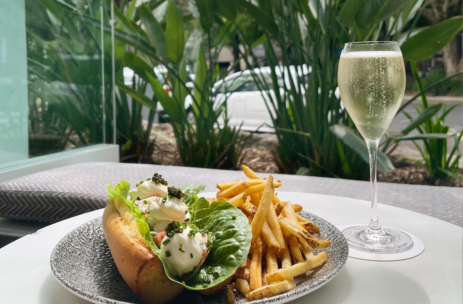 a lobster roll with champagne