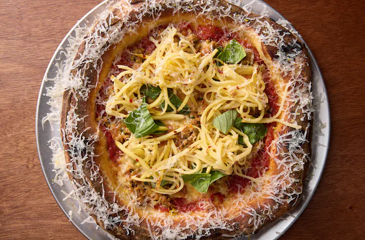 A red sauce-based pizza topped with shredded potato at Norma Taps. 