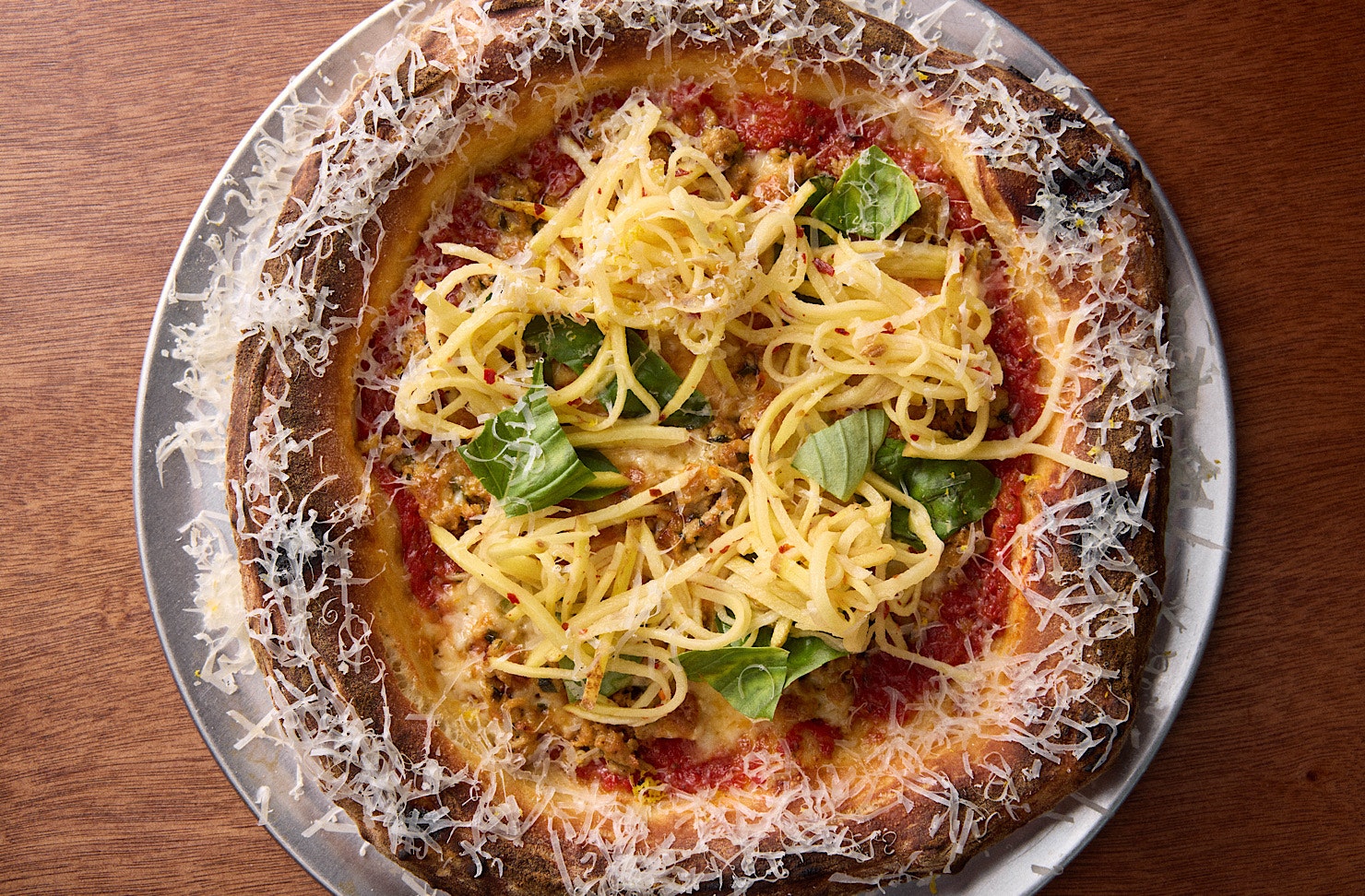 A red sauce-based pizza topped with shredded potato at Norma Taps. 