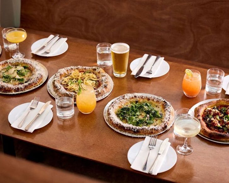 A delectable spread of pizza and bottomless drinks at Norma Taps. 
